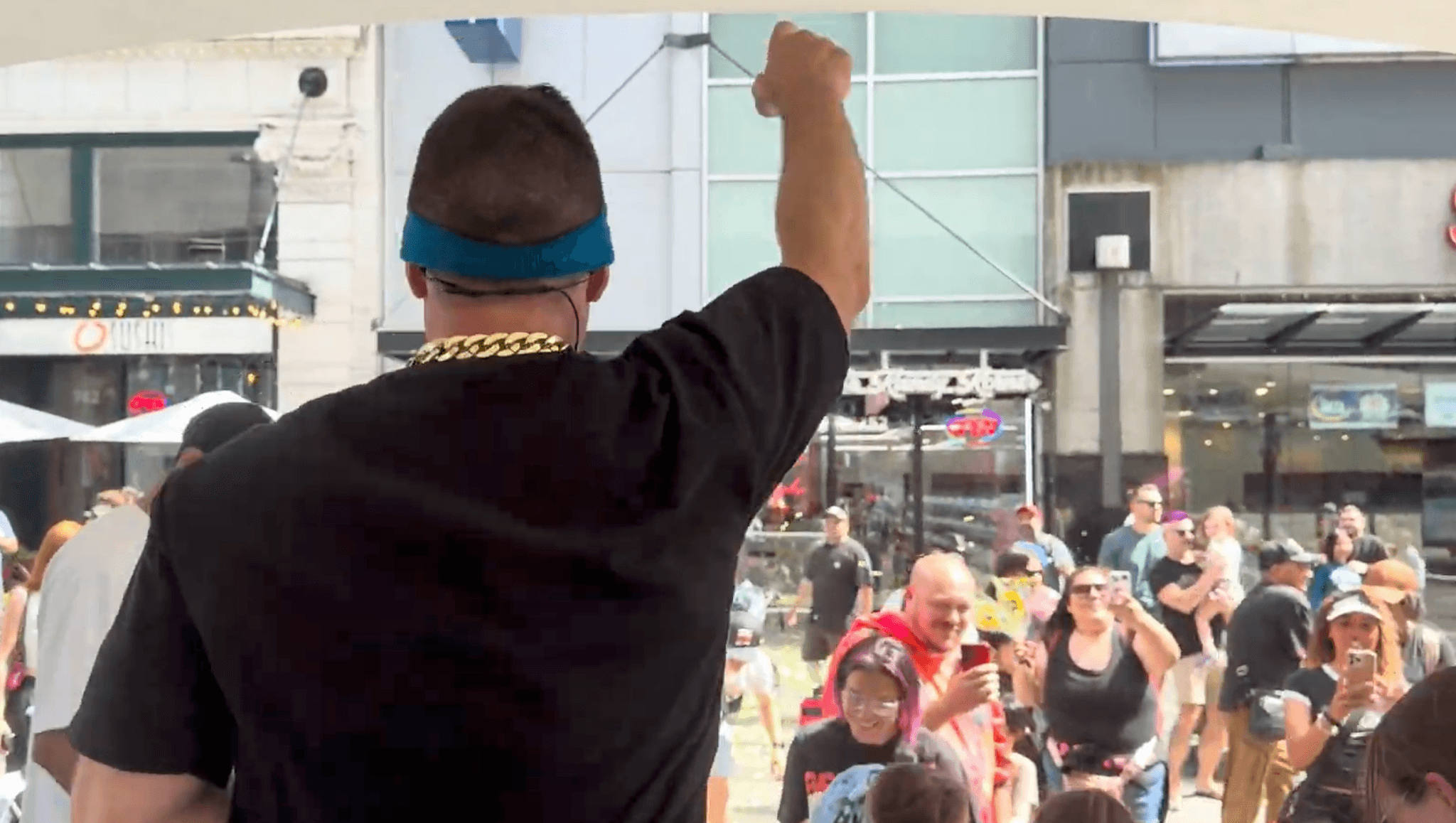 A host leading the crowd at an outdoor Baby Rave event in Vancouver.