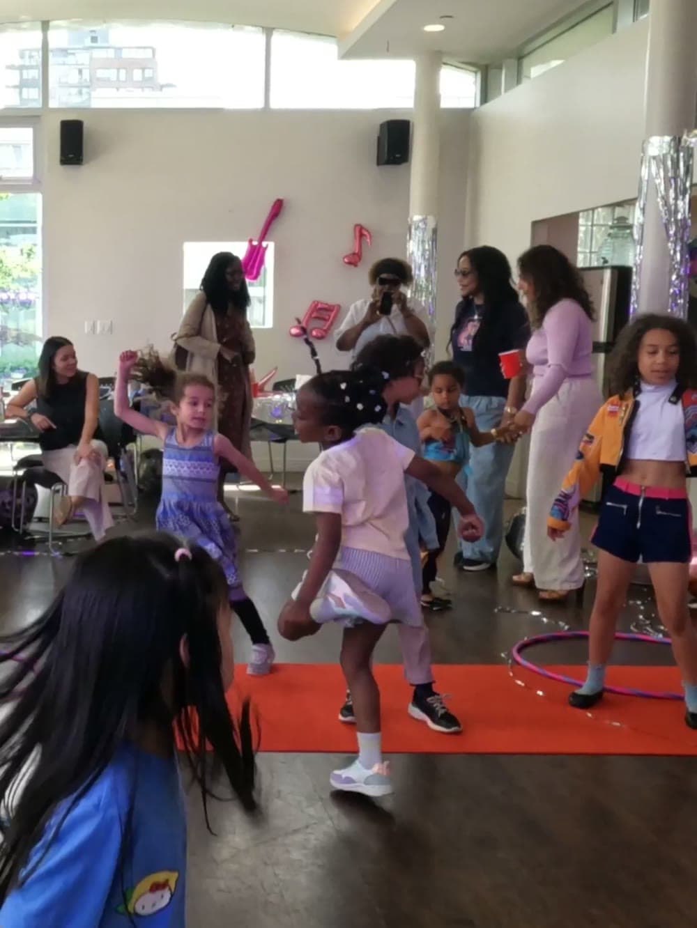Girls dancing with hula hoops and glow sticks at a Vancouver birthday party.
